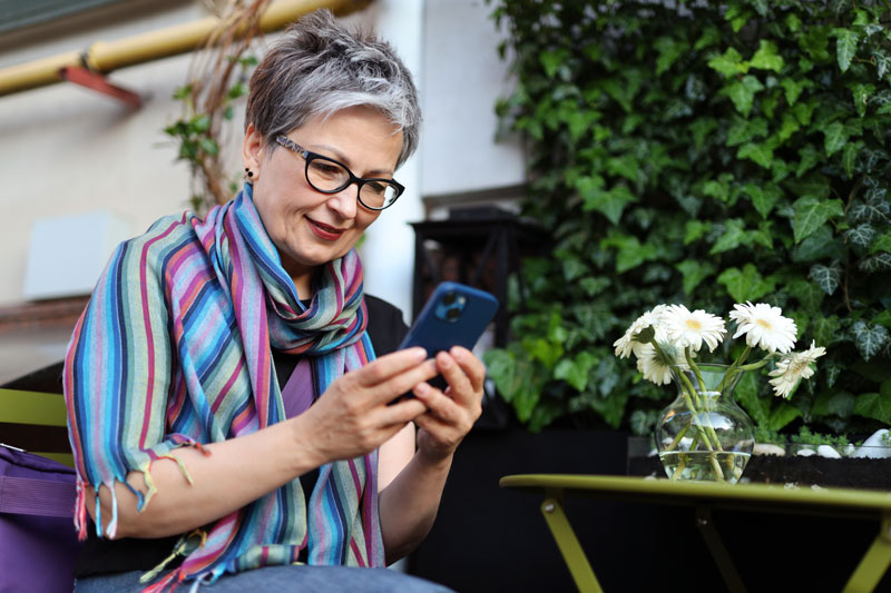 A lady looks down at her smartphone