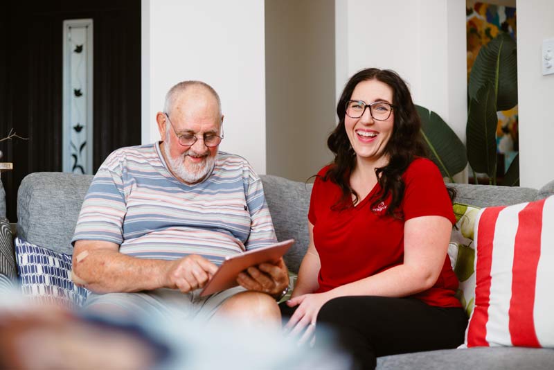An Envigor carer sits with a client to review their care plan