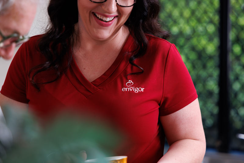 An Envigor carer helps a client