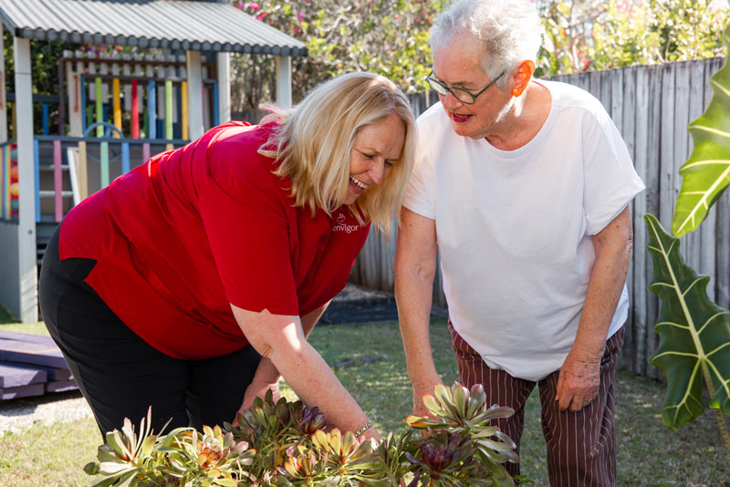 An Envigor carer helps a client with some watering and gardening